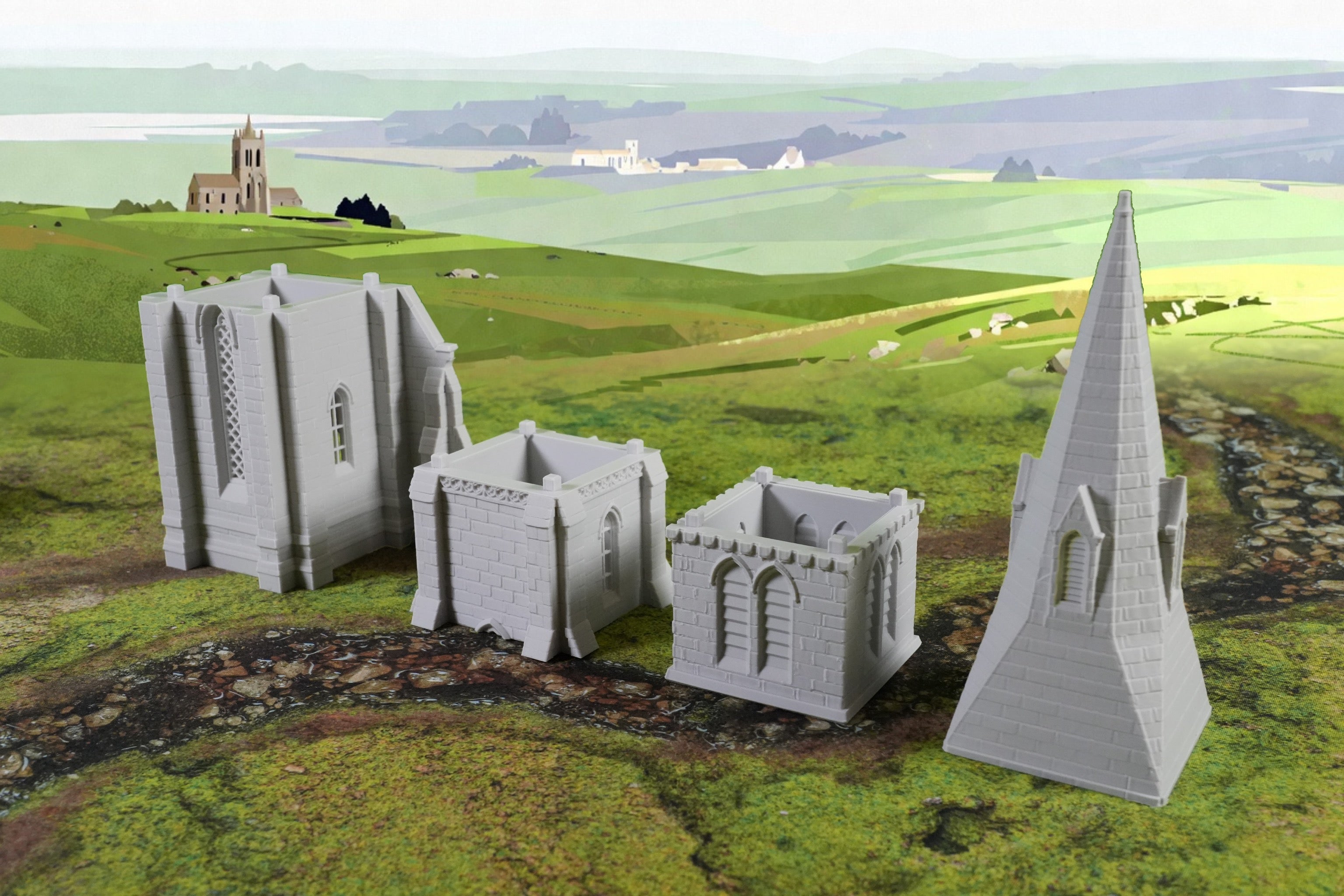 Modell einer mittelalterlichen Kirche aus grauem Material mit separaten Wand- und Turmteilen in Miniaturgröße.