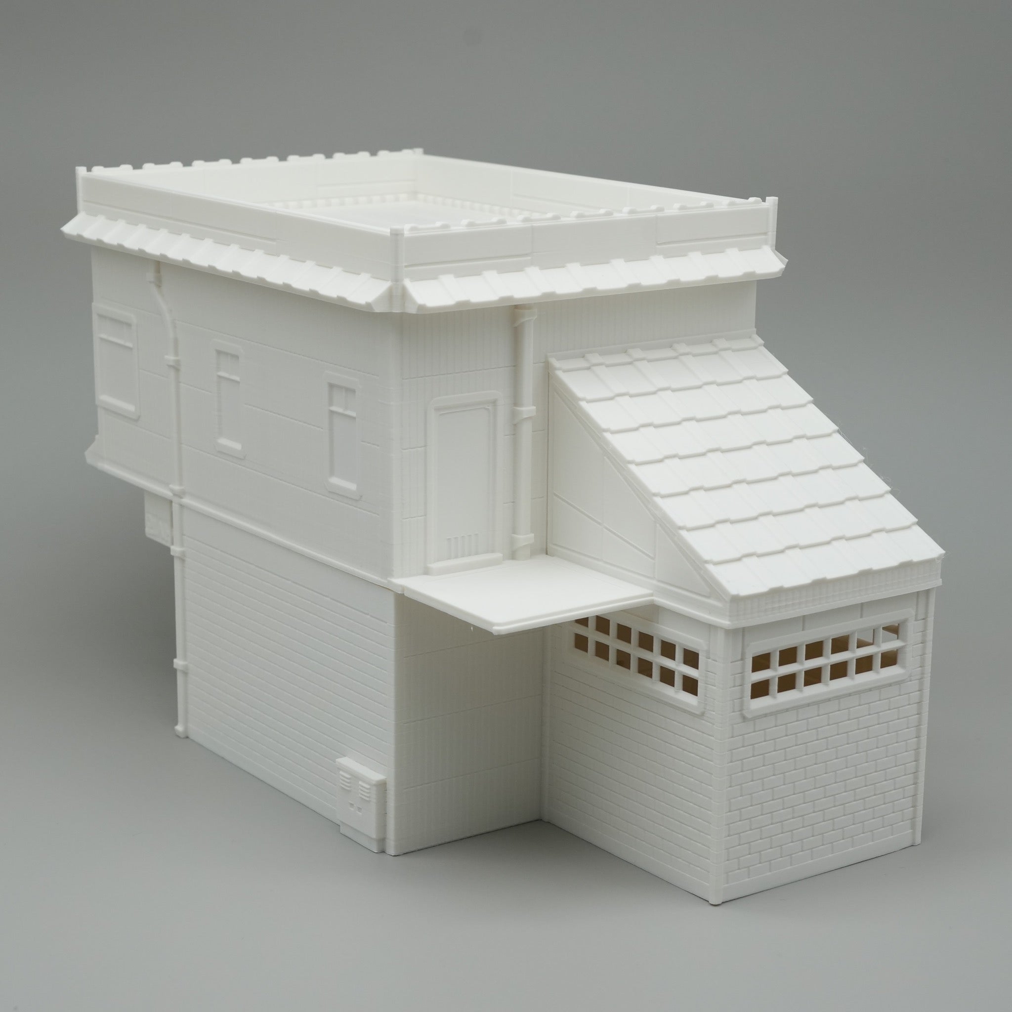 Modernes, weißes medizinisches Gebäude-Modell mit flachem Dach und Anbau mit Fensterladen.