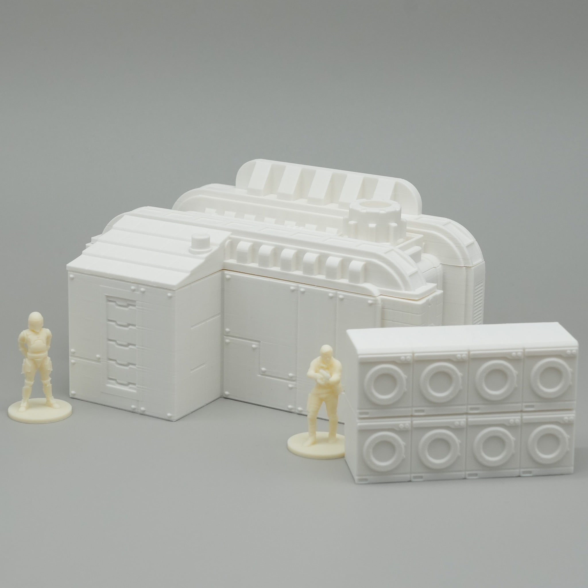 Weiße Miniatur-Gebäudemodelle mit Waschmaschinen und zwei kleinen Figuren, modernes Industrie-Design.