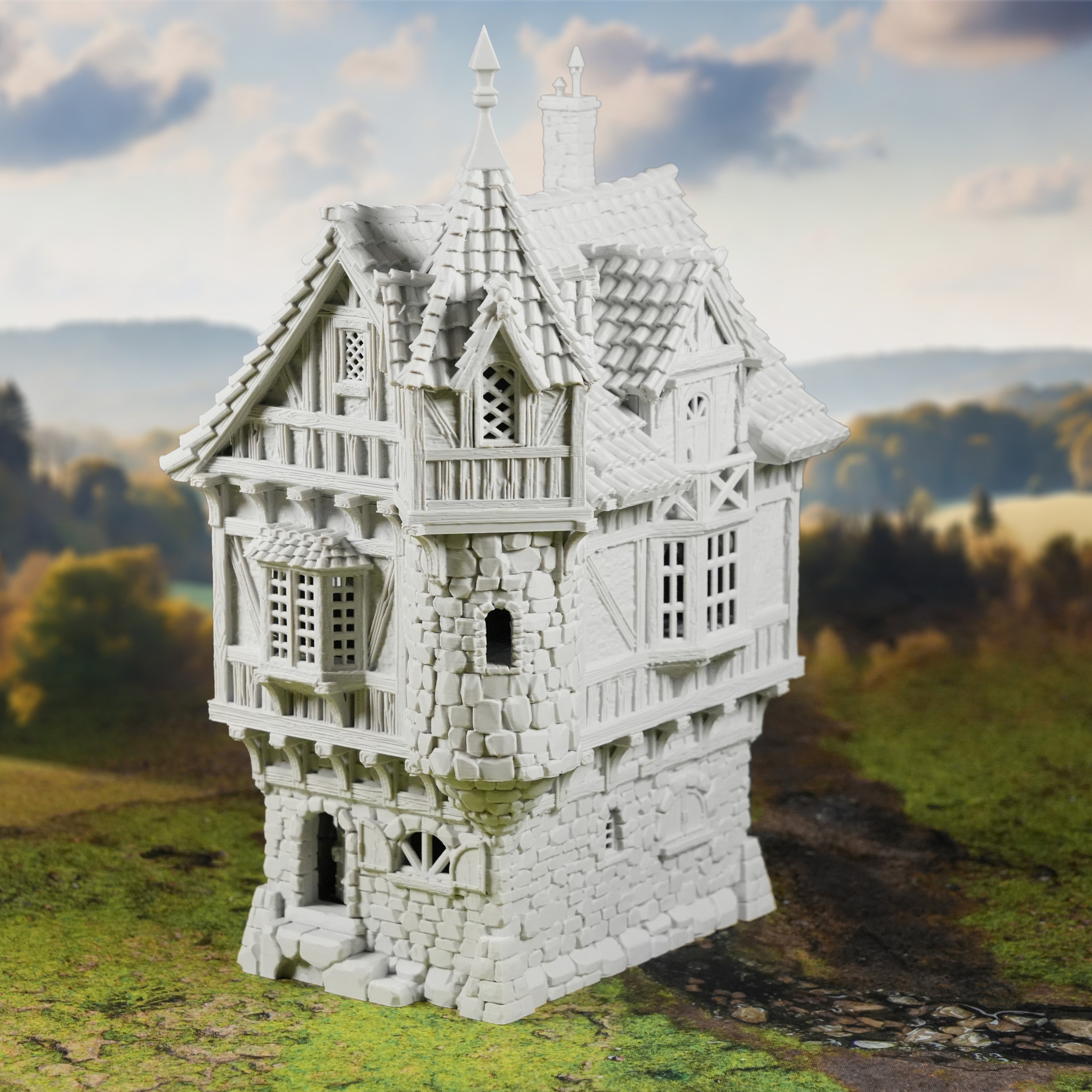 Das "Governors Mansion Herrenhaus" von Nebelstein Prints ist eine detailreiche mittelalterliche Fachwerkminiatur mit Steinsockel und verziertem Dach - ein ideales Tabletop-Gelände für Fantasy-Städte - im Freien zwischen verschwommenen Bäumen und Feldern dargestellt.