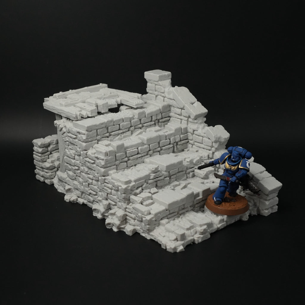 Graue, zerfallene Brückenruine aus Stein mit Treppen und unregelmäßigen Mauerstücken, Miniaturfigur daneben.